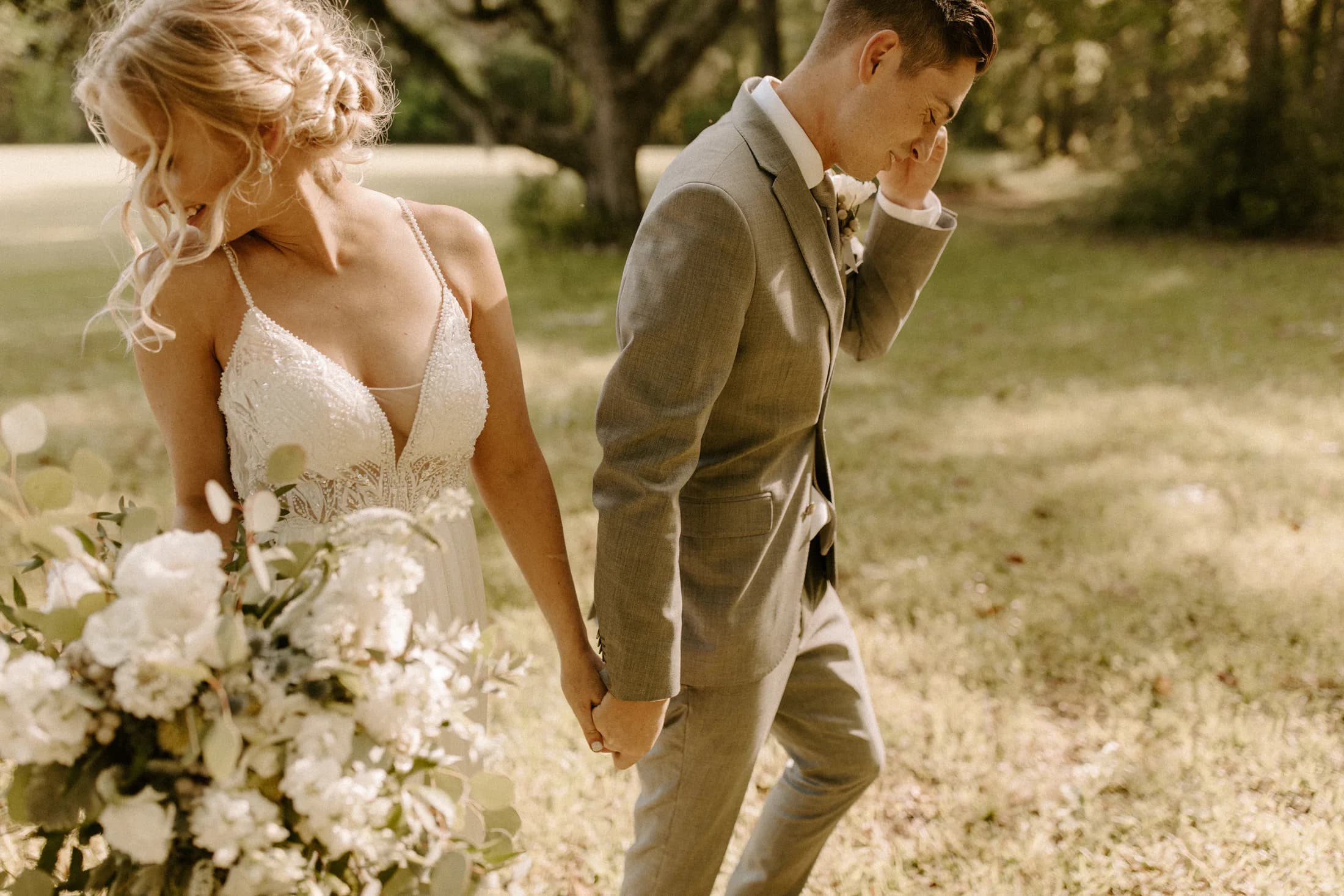 Emma and Joel holding hands on their wedding day